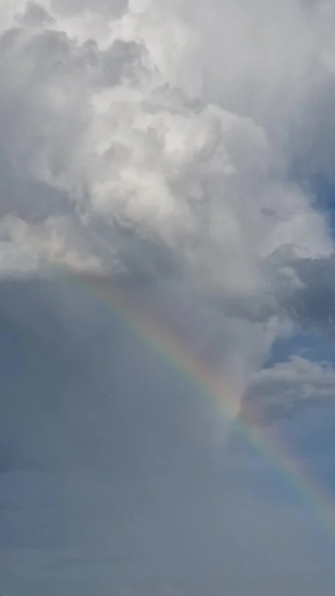 Rainbow in Gentle Rain with Fluffy Clouds Video stock 315456195