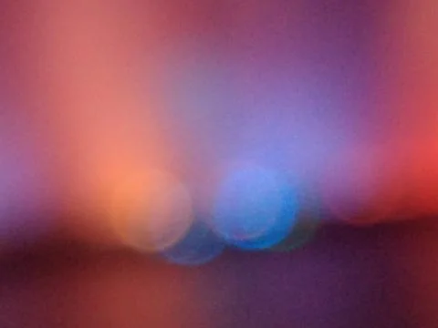 Rainbow gradient color with glowing spots of orange, blue and red, like a fie Stock Photos