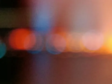 Rainbow gradient color with glowing spots of orange, blue and red, like a fie Stock Photos