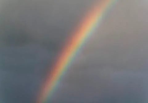 Rainbow on gray sky Stock Photos