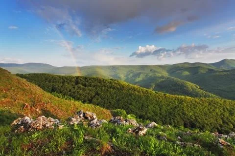 Rainbow in green mountain Stock Photos