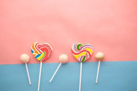 Rainbow heart shape candy on pink Stock-Fotos