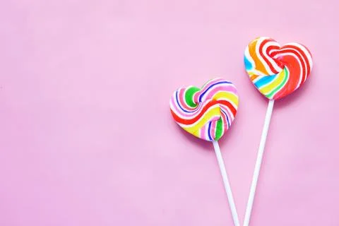 Rainbow heart shape candy on pink Stock-Fotos