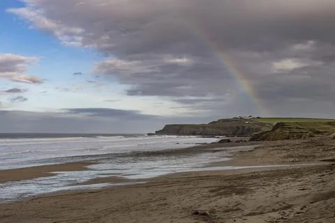 Rainbow hovering over Widemouth Bay Stock Photos