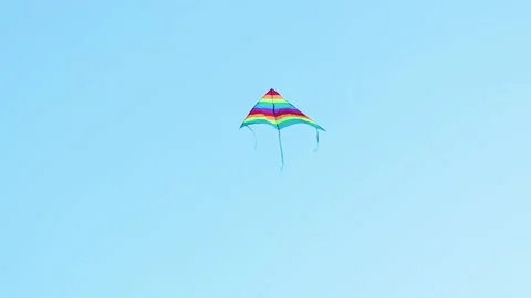 Rainbow kite against blue sky Stock Footage 201601892