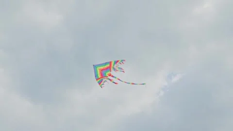 A Rainbow Kite Flies High in the Blue Sky, Creating Joyful Moments with Family Video stock 320948816