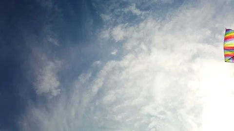 Rainbow kite flying in blue sky Stock Footage 113116848