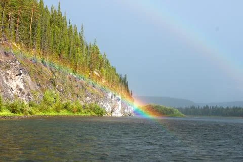 The rainbow lay on the bend of the cliff Stock Photos