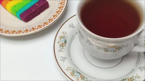 Rainbow Layer Cake Slice and Hot Tea Zooming Close Up Stock Footage 343207803