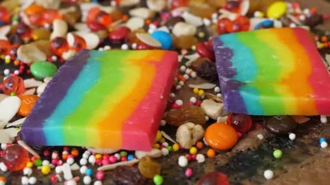 Rainbow Layered Fudge Candy Dessert with Colorful Sprinkles and Toppings Stock Footage 345692680