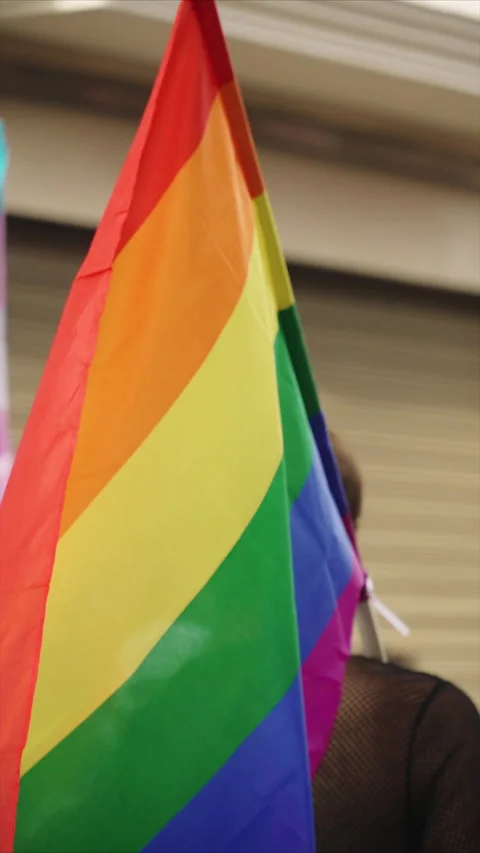 Rainbow lgbt flag on shoulder of unrecognizable person during pride parade. 스톡 동영상 334380898