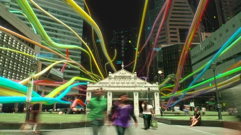 Rainbow licorice candy laces flying through cityscape Stock Footage 150350536