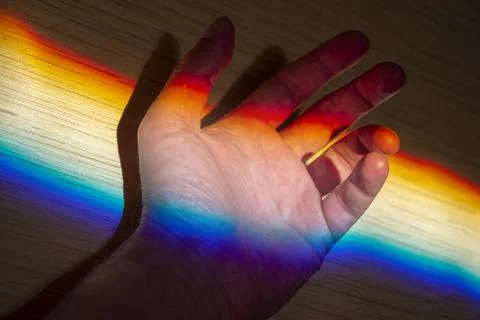 Rainbow light as diffraction on a palm, creativity concept picture Stock Photos