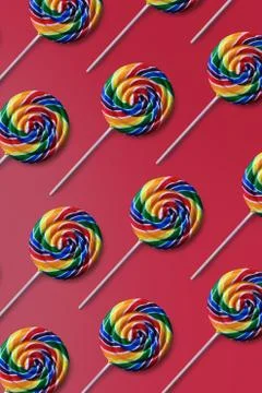Rainbow lollipop pattern on pink background wallpaper Stock Photos