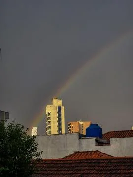 A rainbow in the middle of buildings Stock Photos