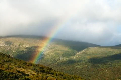 Rainbow in mountains Stock Photos