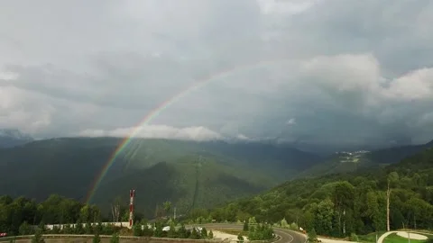 Rainbow in the mountains. A view of the sprawling rare double rainbow in the Stock Footage 141300999