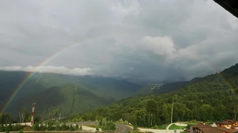 Rainbow in the mountains. A view of the sprawling rare double rainbow in the Stock-Footage 141301020
