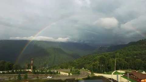 Rainbow in the mountains. A view of the sprawling rare double rainbow in the Stock Footage 142722705