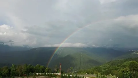 Rainbow in the mountains. A view of the sprawling rare double rainbow in the Stock Footage 142981701