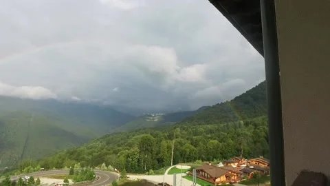 Rainbow in the mountains. A view of the sprawling rare double rainbow in the Stock Footage 157803734