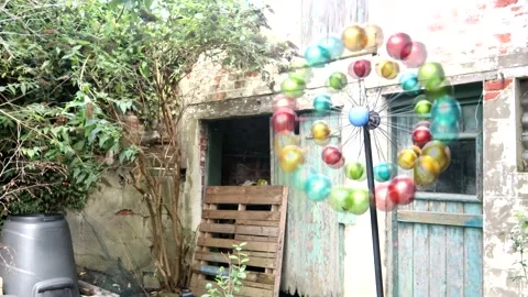 Rainbow Multidirectional Wind Spinner In Front Of A Very Old Coach House 스톡 동영상 138043873