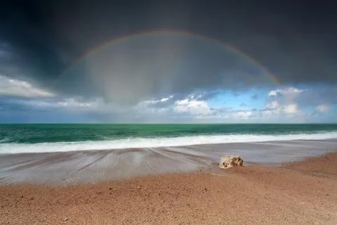 Rainbow on ocean beach Foto stock