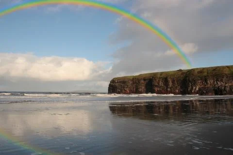Rainbow over the ballybunion beach cliffs Stock Photos