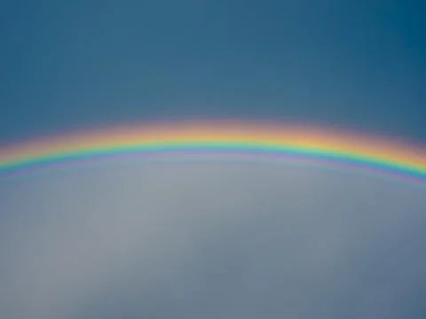Rainbow over blue sky Stock Photos