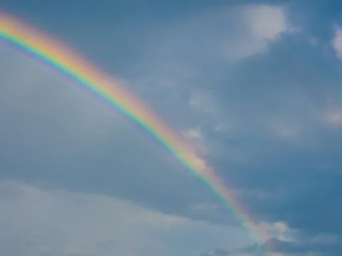 Rainbow over blue sky Stock Photos