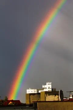 Rainbow over the buildings. Stock Photos