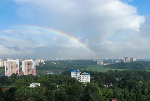 Rainbow Over Cityscape Stock Photos