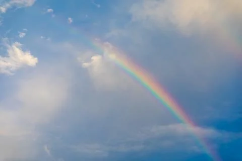 Rainbow over cloudy sky after raining. Stock Photos