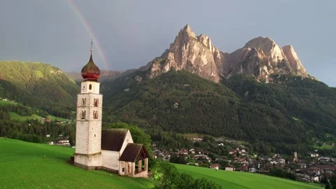 Rainbow over the Dolomites behind St Valentin church, Kastelruth Stock Footage 346288725