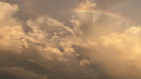 Rainbow Over Dramatic Cumulus Clouds at Evening Sunset Stockbeeldmateriaal 296002723