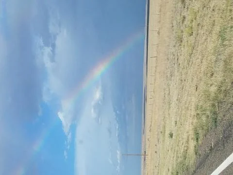 Rainbow over field Stock Photos