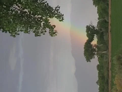 Rainbow over field Stock Photos