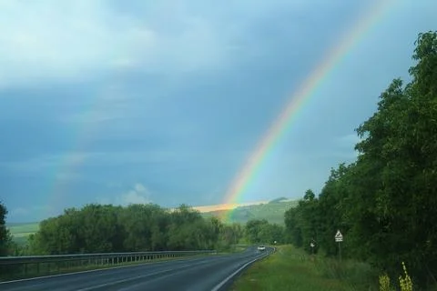 Rainbow over field Stock Photos