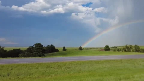 Rainbow over the fields and road Stock Footage 248119848