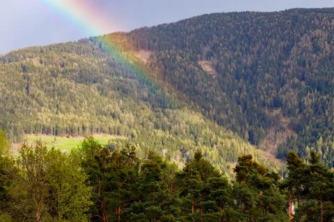 Rainbow over Forested Hillside Stock Photos