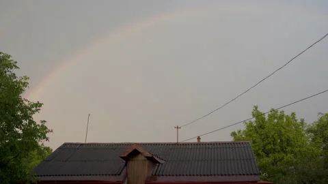 Rainbow over the house in the rain Stock Footage 203820266