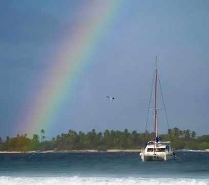 Rainbow over the island. Stock Photos
