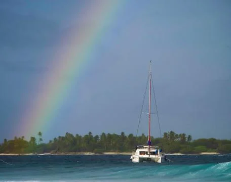 Rainbow over the island. Stock Photos