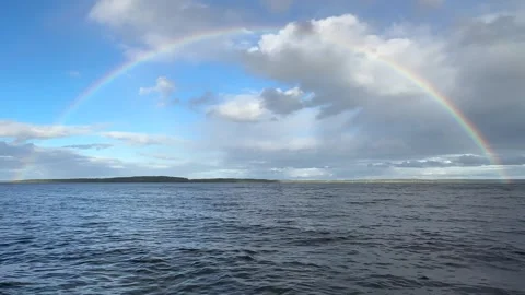 Rainbow over a lake Stock Footage 284864707