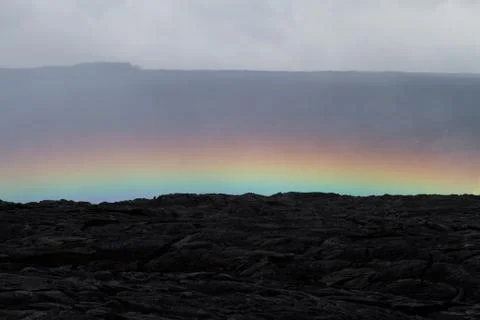 Rainbow over a lava field Foto stock