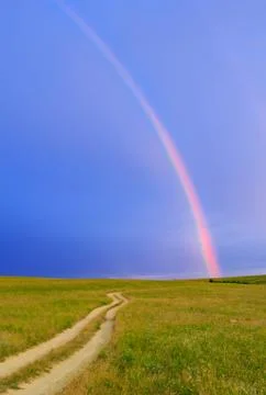 Rainbow over the meadow Stock Photos