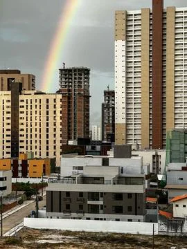 Rainbow over the modern city Stock Photos