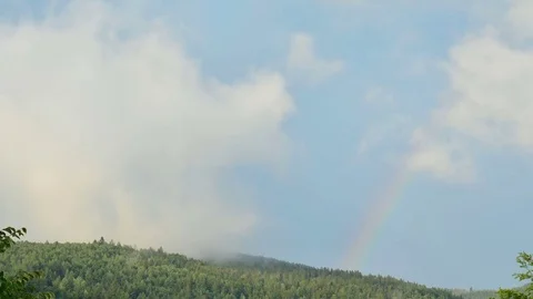 Rainbow over the mountain. Timelapse. Stock Footage
