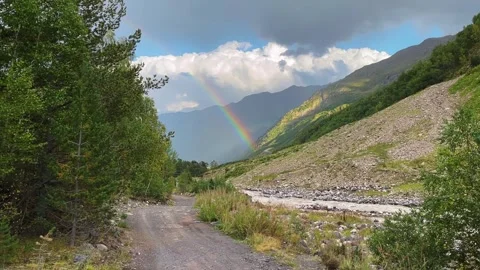 Rainbow over mountain valley with river, forest trail Stock Footage 336867088