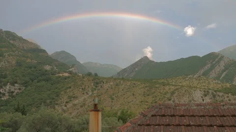 Rainbow over the mountains - Time lapse Stock Footage 100988741